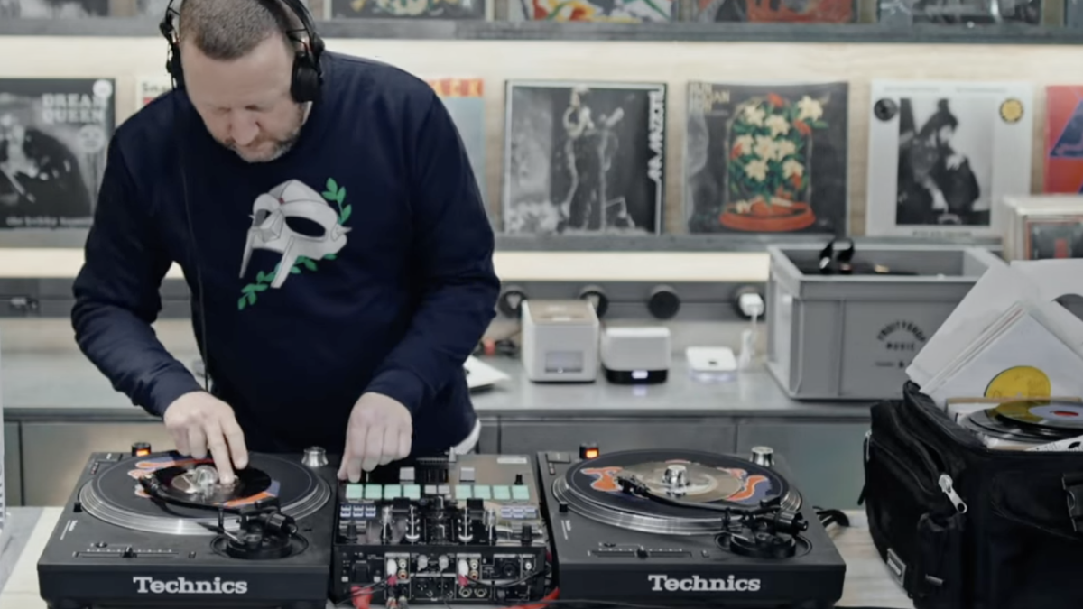 DJ Mr Thing is scratching a seven-inch record.