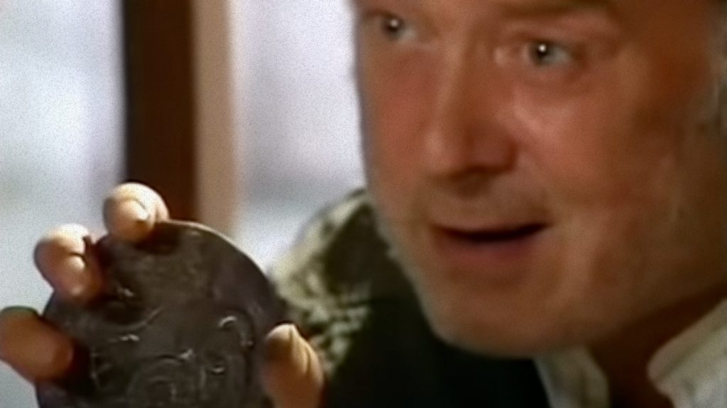 Dai Holds up an amulet.