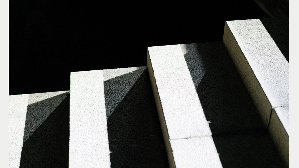 The cover of S/T by Angélica Salvi, Ece Canlı, João Pais Filipe e Pedro Augusto featuring a black and white image of a stairway